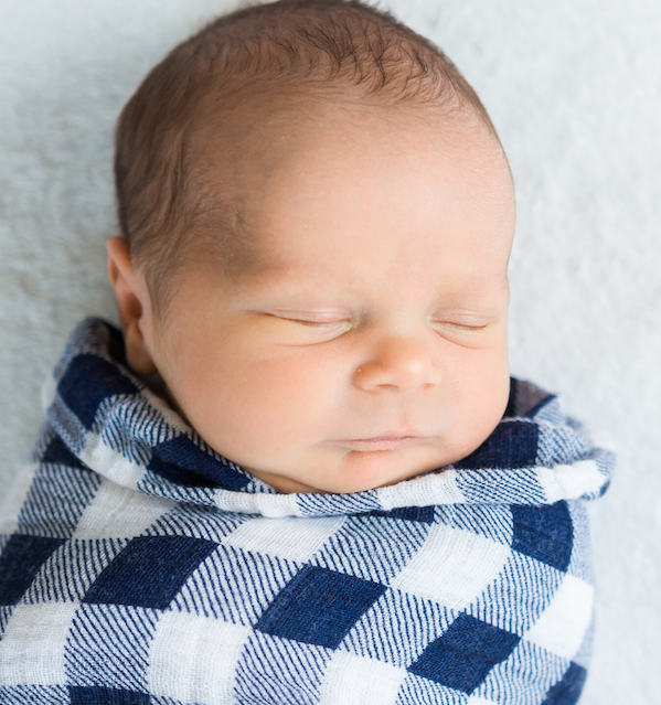 Baby wrapped in a swaddle